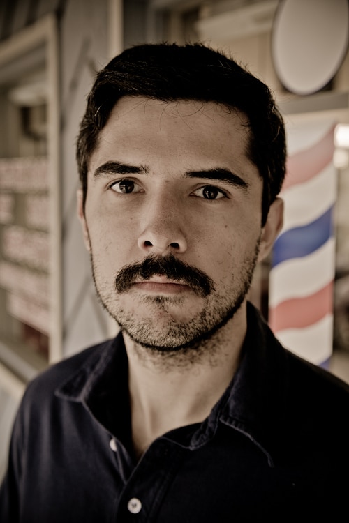 AoM_Shaving-7 A man before the shave standing outside the barbershop.