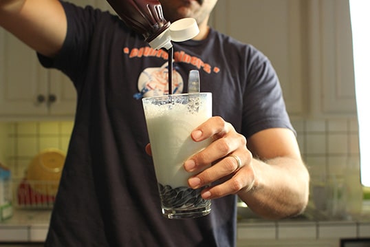 Men Dropping the chocolate in glass.