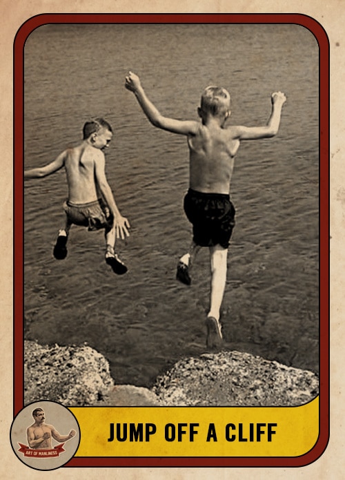 Vintage boys jumping off a cliff into a lake.