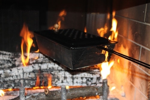roasting chestnuts Roasting chestnuts in the pan on fireplace.