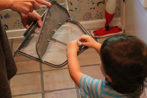 Cleaning out the lint from the dryer.