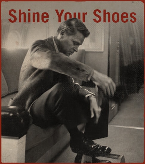 Man is shining his shoes.