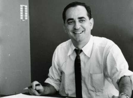 A man sitting at a desk with papers in front of him as part of his morning routine.